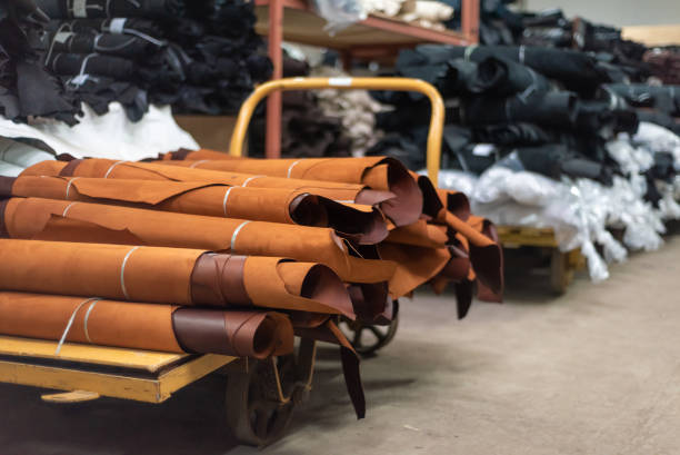 Leather production. Rolls of brown leather on a trolley in a warehouse.